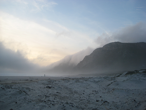 *A lone person walking on Scarborough beach.*